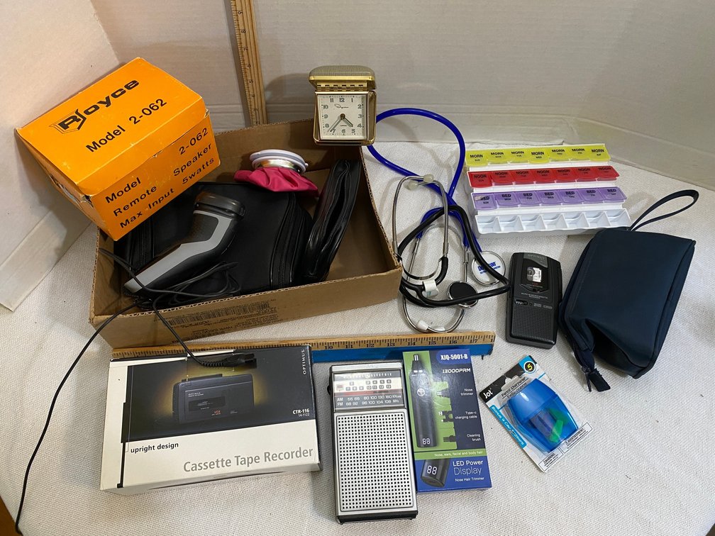 Optimus recorder, GE radio, razor, speakers, pill sorter, stethoscope, pencil sharpener