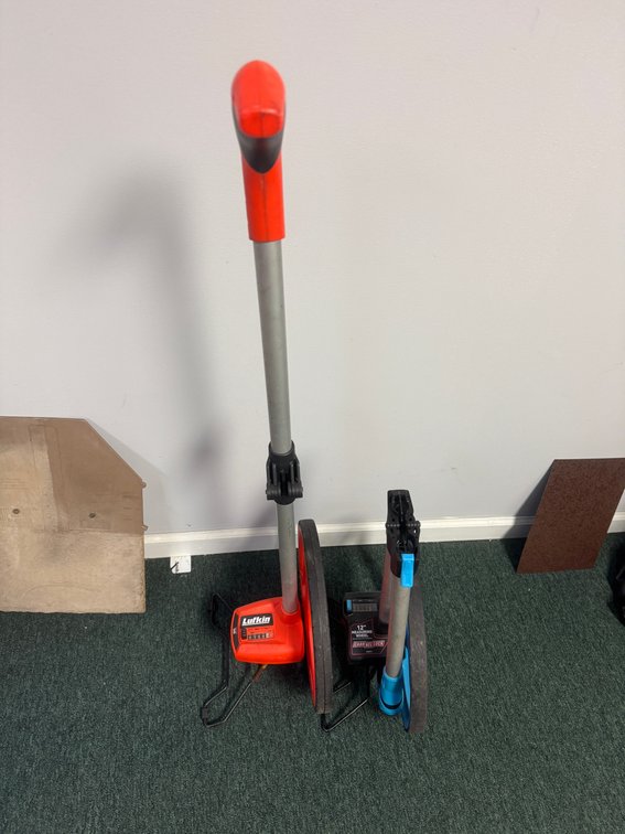 Two measuring wheels, including a Lufkin measuring wheel and a Channellock
