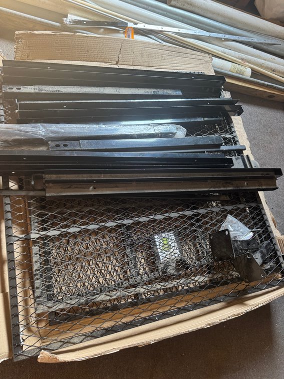 Assorted black expanded-metal frames, grates, and metal components.