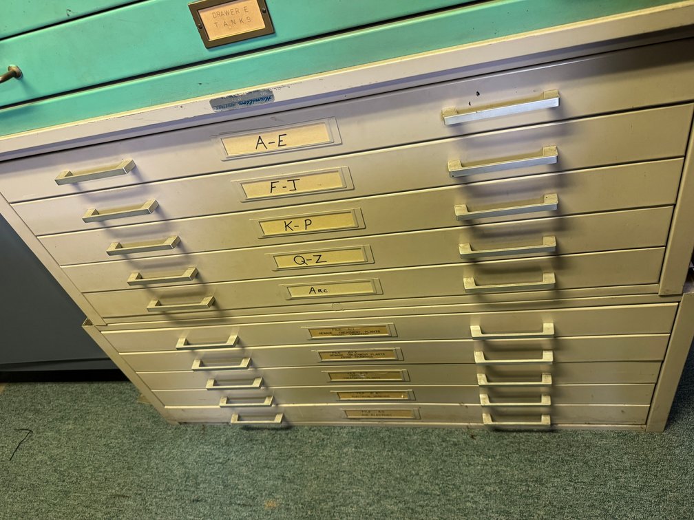 Large flat-file/map cabinet with multiple wide drawers, label holders, and metal handles for organizing plans, drawings, maps, or documents.