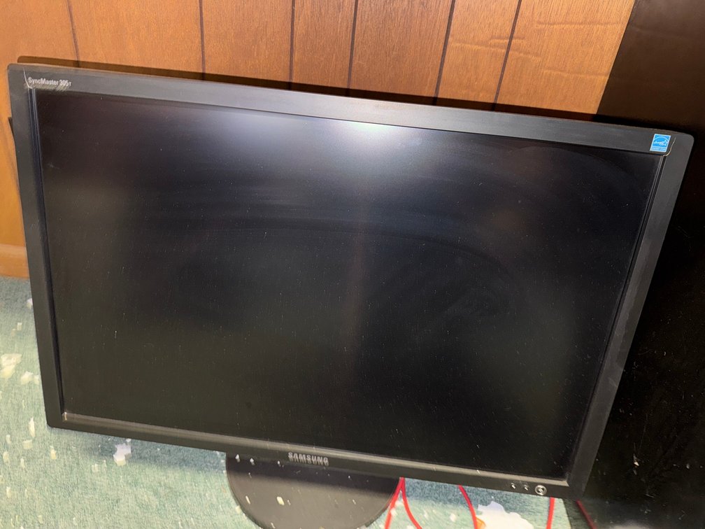 Samsung SyncMaster widescreen LCD monitor with adjustable stand.