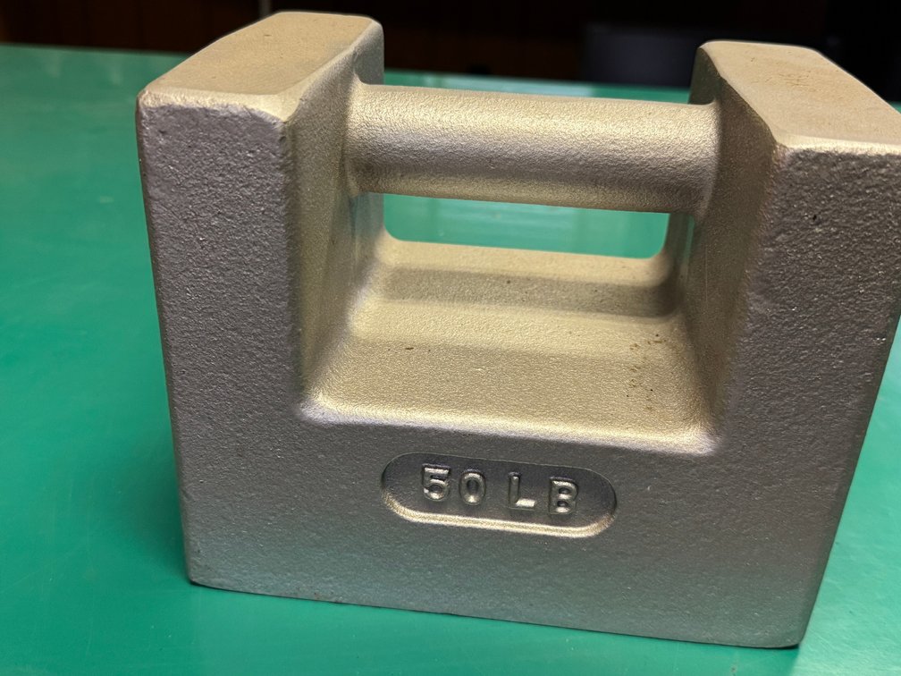 50 lb calibration/test weight with built-in carrying handle and heavy-duty cast construction.