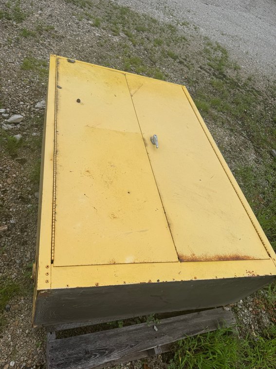 Yellow steel storage/tool box with hinged top lid and side access fitting.