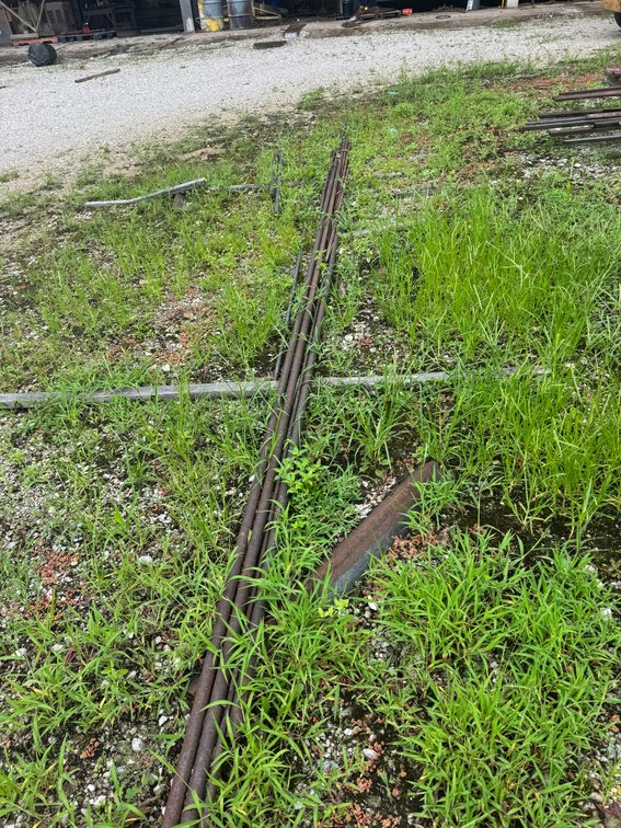 Assorted lengths of steel pipe and metal rods