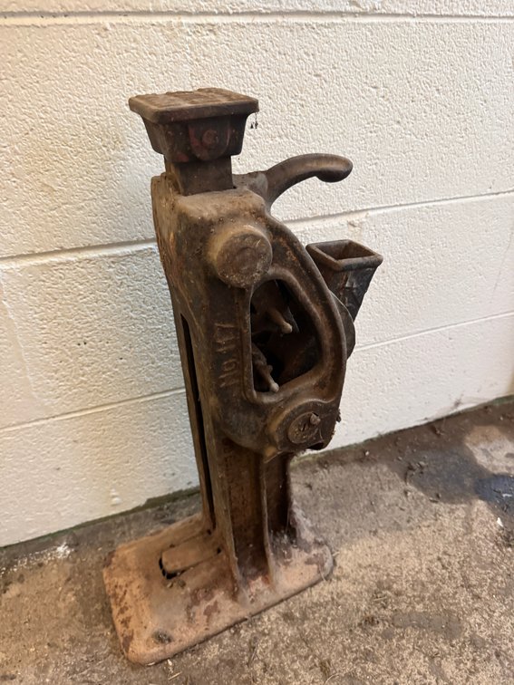 Vintage mechanical railroad/industrial jack with heavy cast-iron construction.