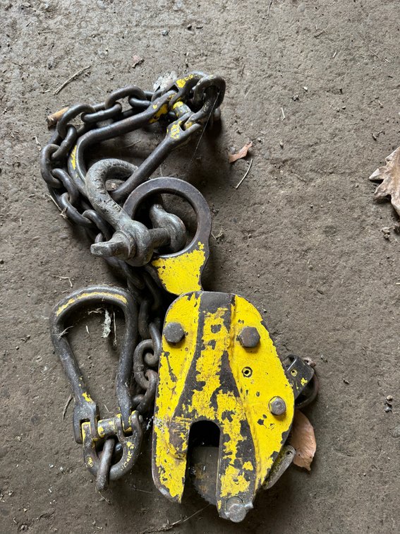 Heavy-duty lifting/rigging assembly with chain, shackles, hook, and plate-style lifting clamp.