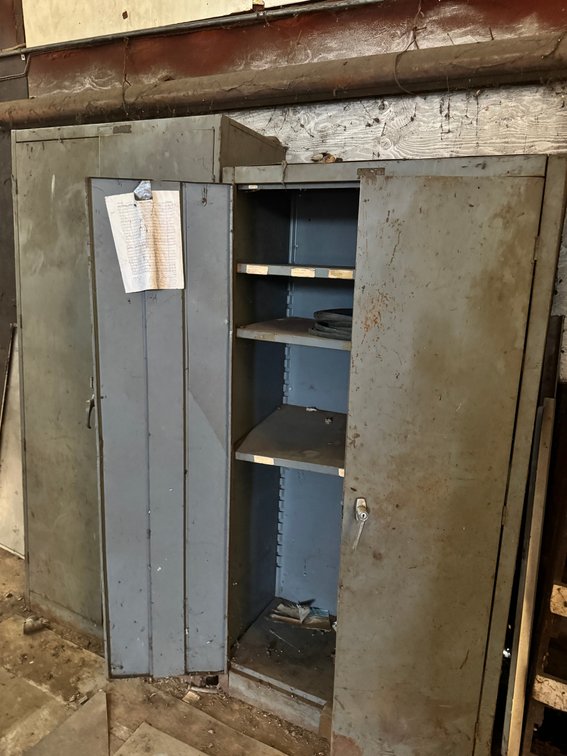 Heavy-duty metal storage cabinet with double doors and adjustable shelving.