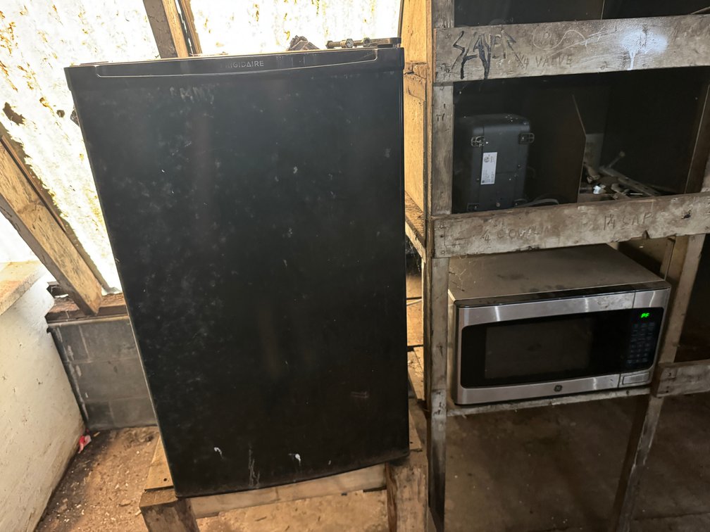 Frigidaire compact refrigerator and GE countertop microwave.