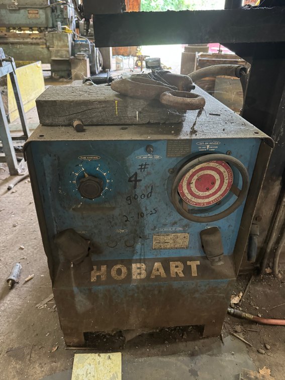 Hobart industrial welder/power unit with adjustable controls and heavy-duty cabinet.