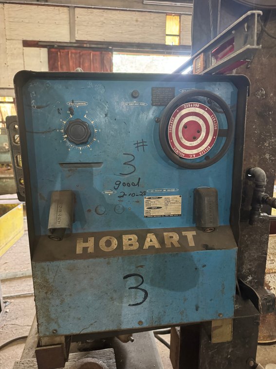 Hobart industrial welder/power unit with adjustable controls and heavy-duty cabinet.