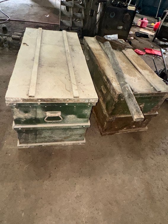 Pair of heavy-duty metal storage/tool boxes with hinged lids and carrying handles.