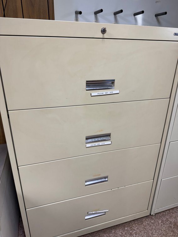 Beige 4-drawer lateral filing cabinet with lock and label holders.