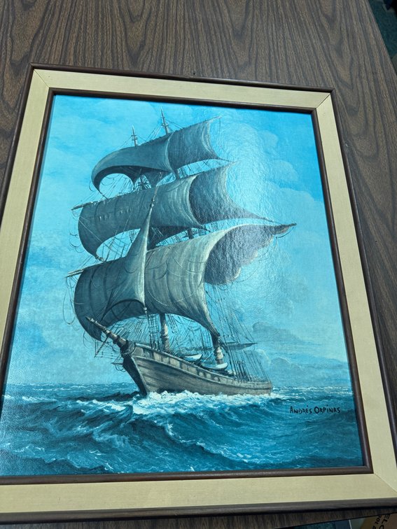Framed nautical artwork featuring a multi-masted sailing ship at sea.