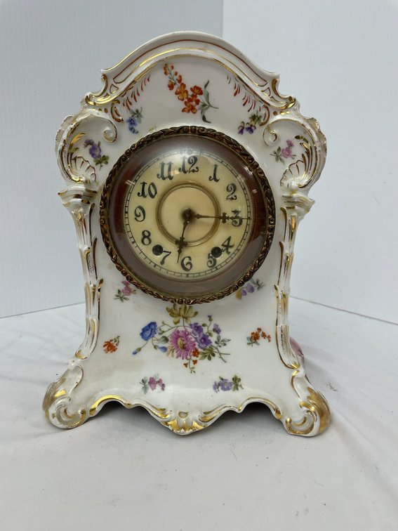 Floral decorated porcelain clock with gold trim-with key