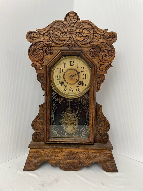 Antique wooden gingerbread mantle clock-ornate carved wooden case-etched glass lower panel-with key