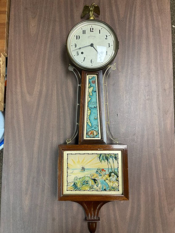 Ingraham banjo clock decorated in picture island painting-with key-made by Ingraham Company, Bristol, Connecticut