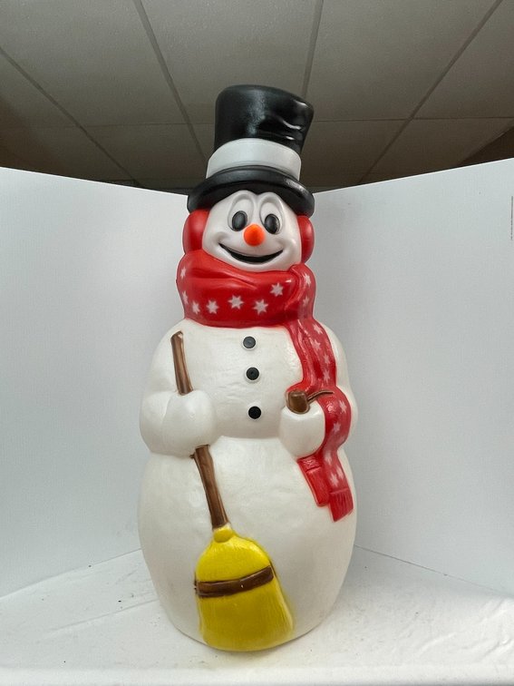 Vintage snowman blow mold decorated with red star scarf and broom