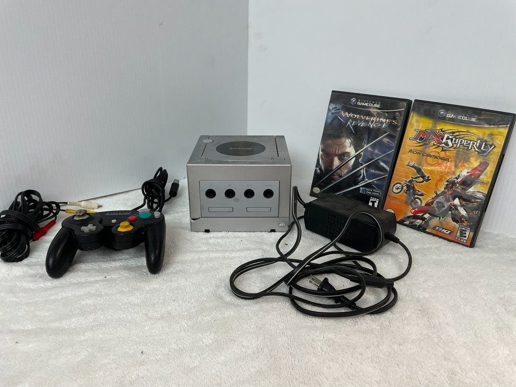 1 Silver Nintendo game cube with 1 controller, AV cables, power supply, MX Superfly, Wolverine's Revenge