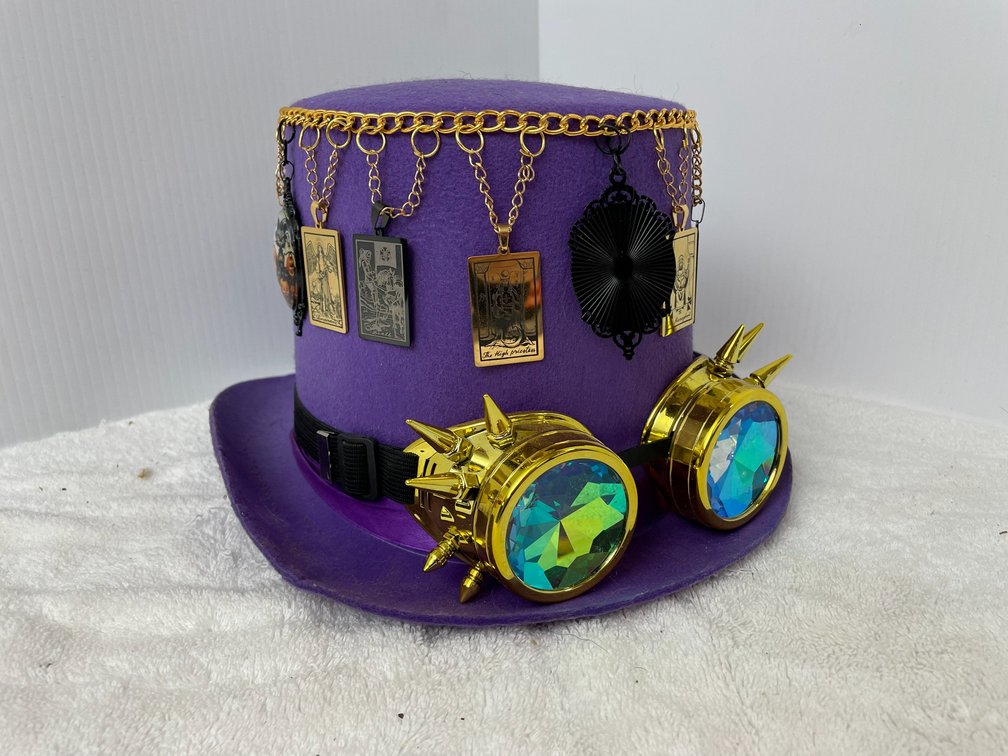Purple felt hat with decorations of badges and kaleidoscope goggles