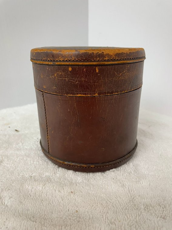 Antique leather round box for collars and cuffs with embossed top of a lion and unicorn