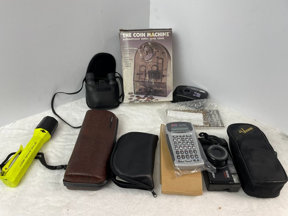 Men's electric razor, flashlight, Vivitar camera, coin counter, Auto Pilot