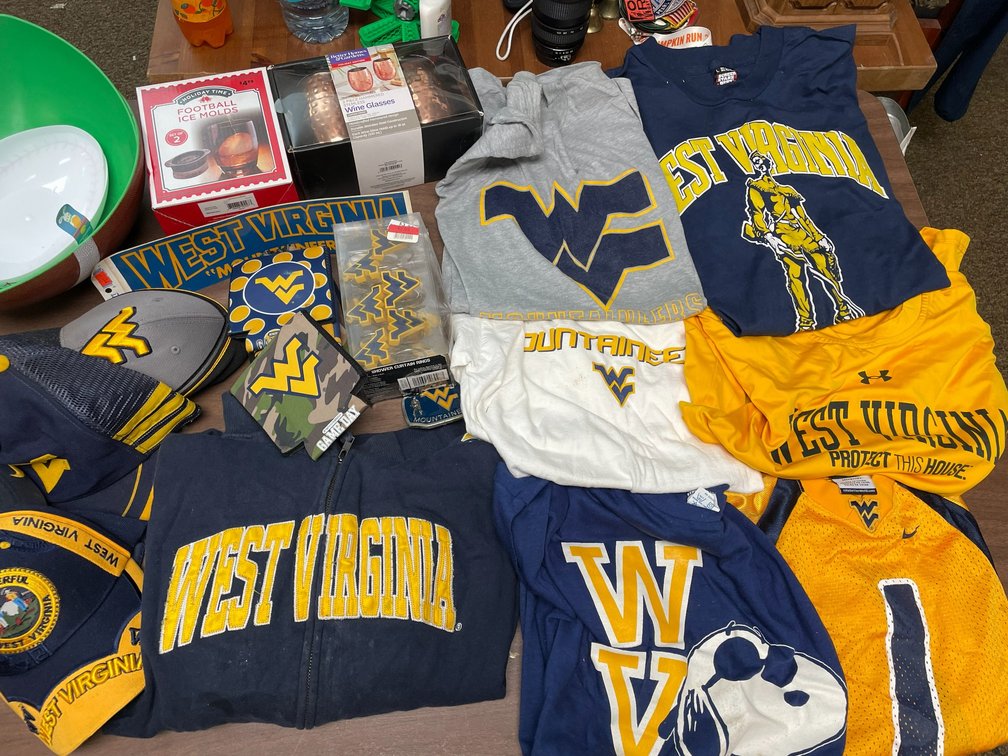 Collection of WV shirts-sizes ranging from S-XL, serving bowls for football games, hats, koozies, shower rings, football ice molds, WVU Mountaineers belt buckle