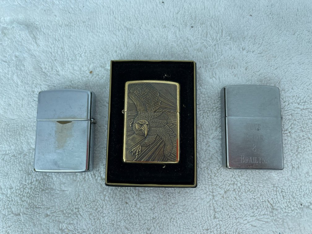 3 Lighters-gold Zippo with eagle, Zippo with white GMC, Zippo with engraving