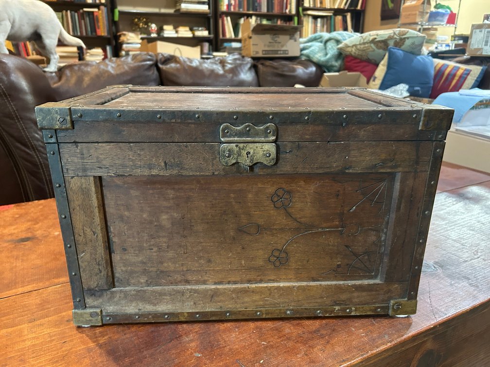 Early small trunk with metal bands on side and detailed carvings