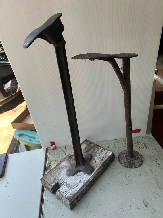 Antique iron shoe lasts on stands
