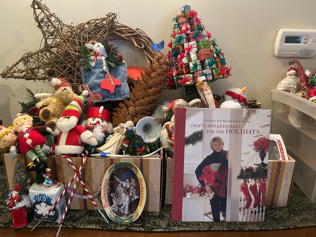Christmas decorations-present tree, wooden Santas, tin advertising pieces, Martha Stewart book