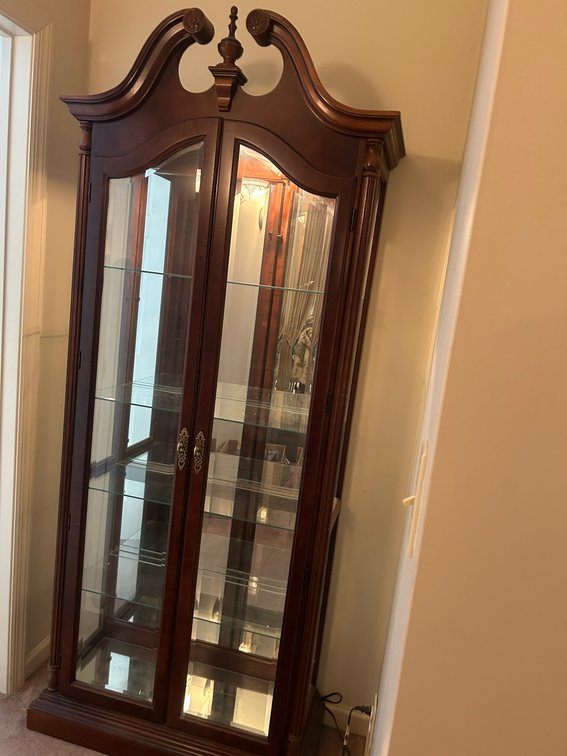 Lighted curio cabinet with beveled glass doors and glass shelves