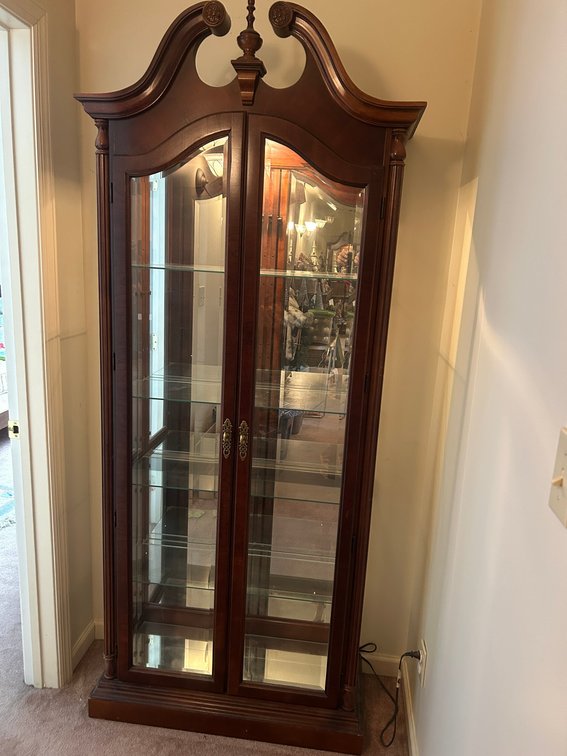 Lighted curio with beveled edge glass doors and glass shelves