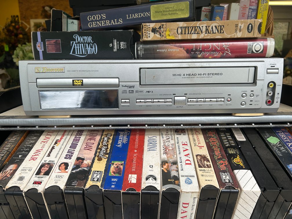Rolling cart with box of VHS tapes, VCR