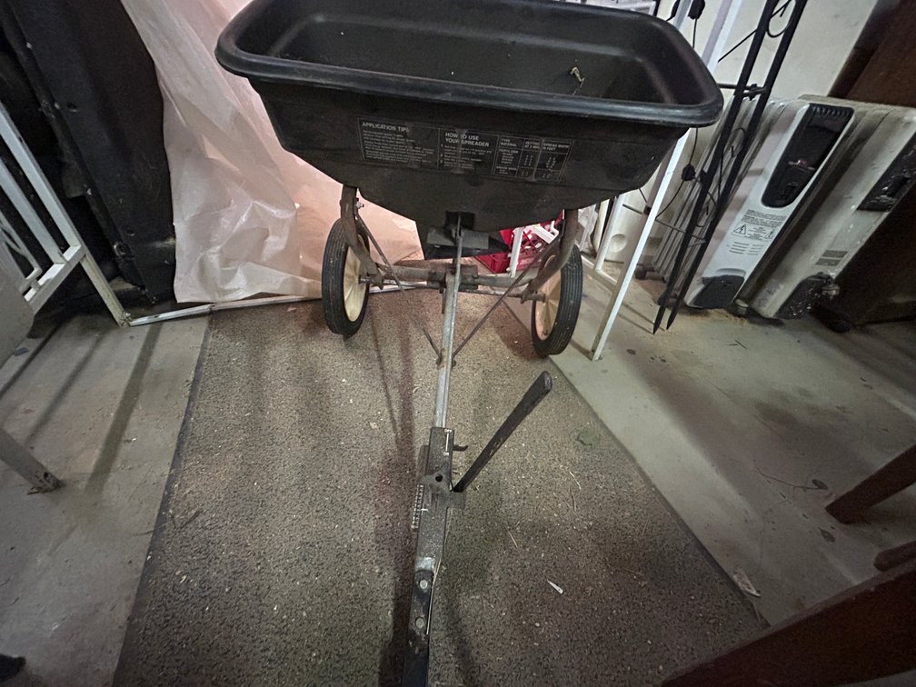 Pull behind seed spreader