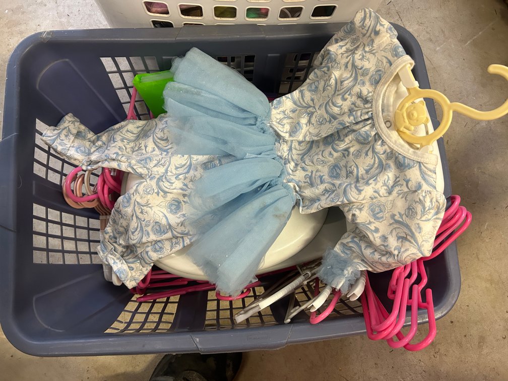 Laundry basket with doll dress, hangers