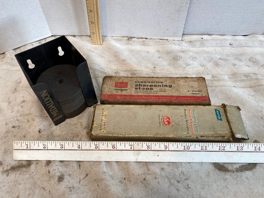 Norton cut-off wheels in storage holder, sharpening stones