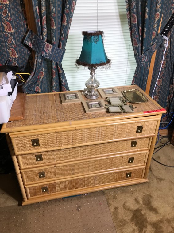 Rattan dresser with electric lamp, wall hangings