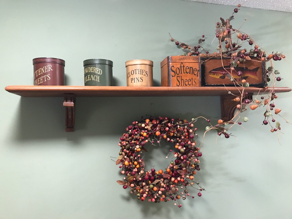 Decorative storage cans, wreath, wooden shelf, etc.
