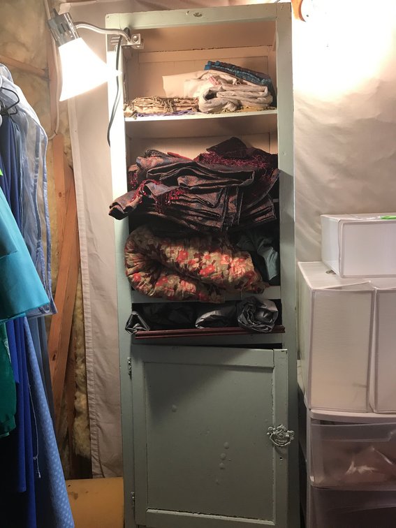Wooden cabinet-contents included with linens
