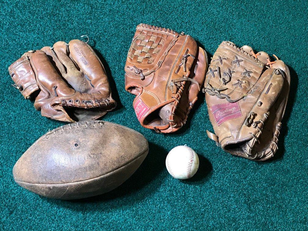 3 Baseball gloves, football, misc.
