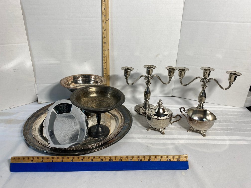 COLLECTION OF SILVER PLATE SERVING ITEMS AND A PAIR OF CANDELABRAS
