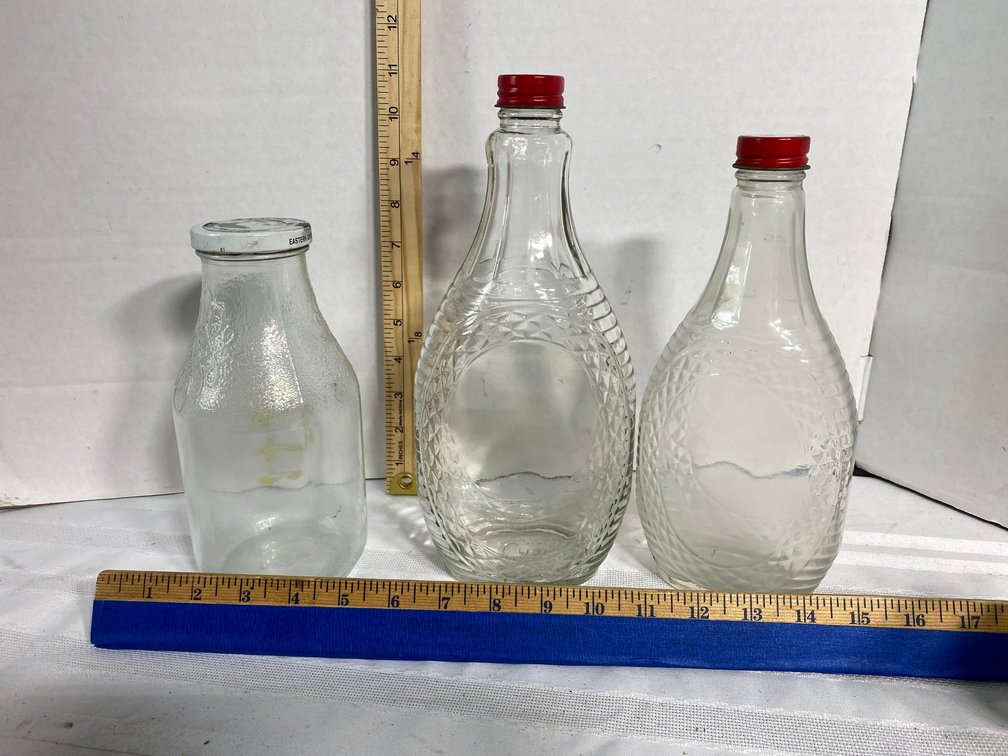 THREE VINTAGE GLASS BOTTLES WITH LIDS