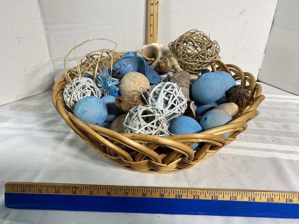 NAUTICAL THEMED WOVEN BASKET WITH ROUND DECOR PIECES IN IT