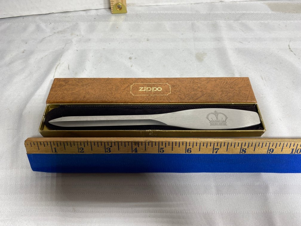 STAINLESS STEEL ZIPPO LETTER OPENER WITH CROWN DETAIL ON IT
