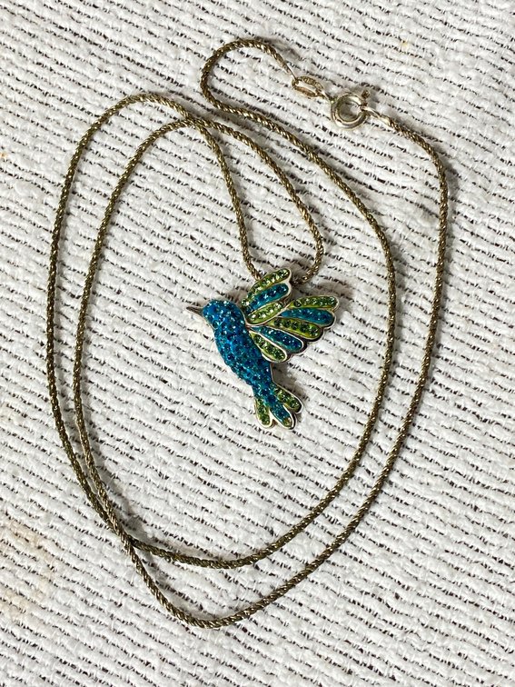 NECKLACE MARKED 925 WEIGHS 7.5 GRAMS AND IT IS 20 INCHES LONG WITH A BIRD CHARM