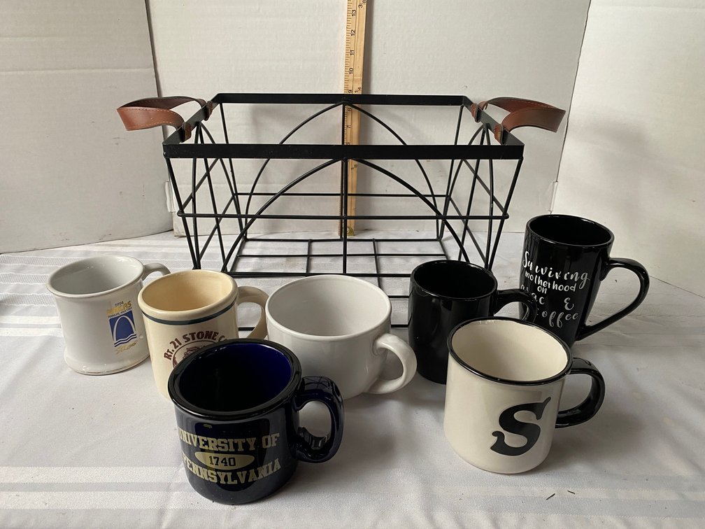 14 INCH LONG METAL BASKET WITH FAUX LEATHER HANDLES AND MISCELLANEOUS COFFEE CUPS