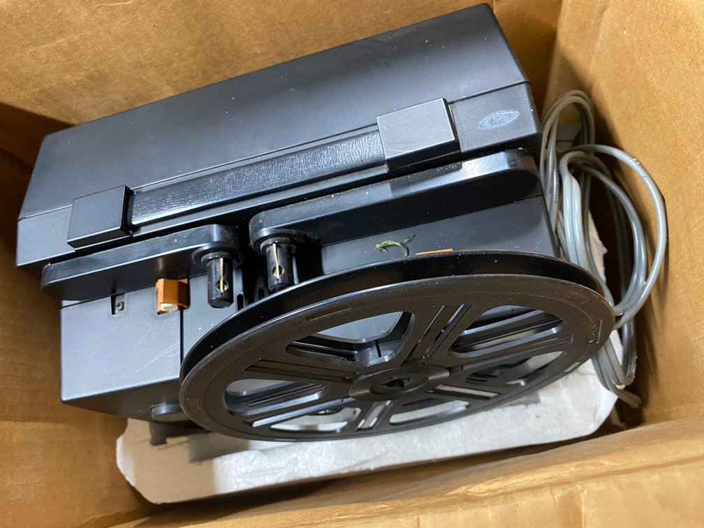 BELL AND HOWELL MODEL 33SR SUPER 8 PROJECTOR AND A PROJECTOR SCREEN
