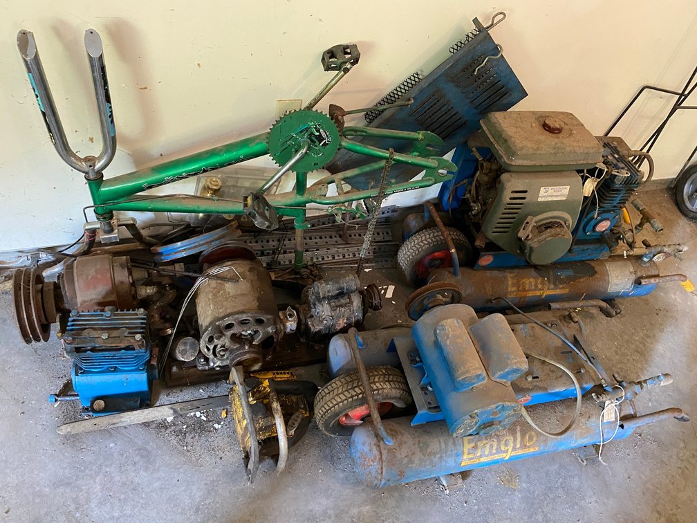 2 Portable air compressors-1 has gasoline engine and motor does turn over, other is electric and has been taken apart-misc. electric motors, belt driven hydraulic pump, chainsaw, bicycle frame**all in unknown condition**