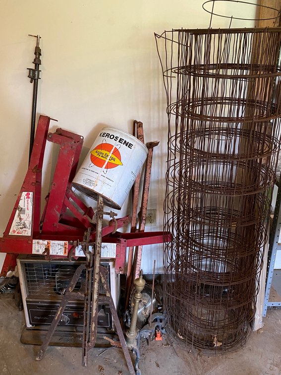 Partial roll of wire for concrete reinforcement, set of ladder jacks, kerosene heater, saw blades, pick heads