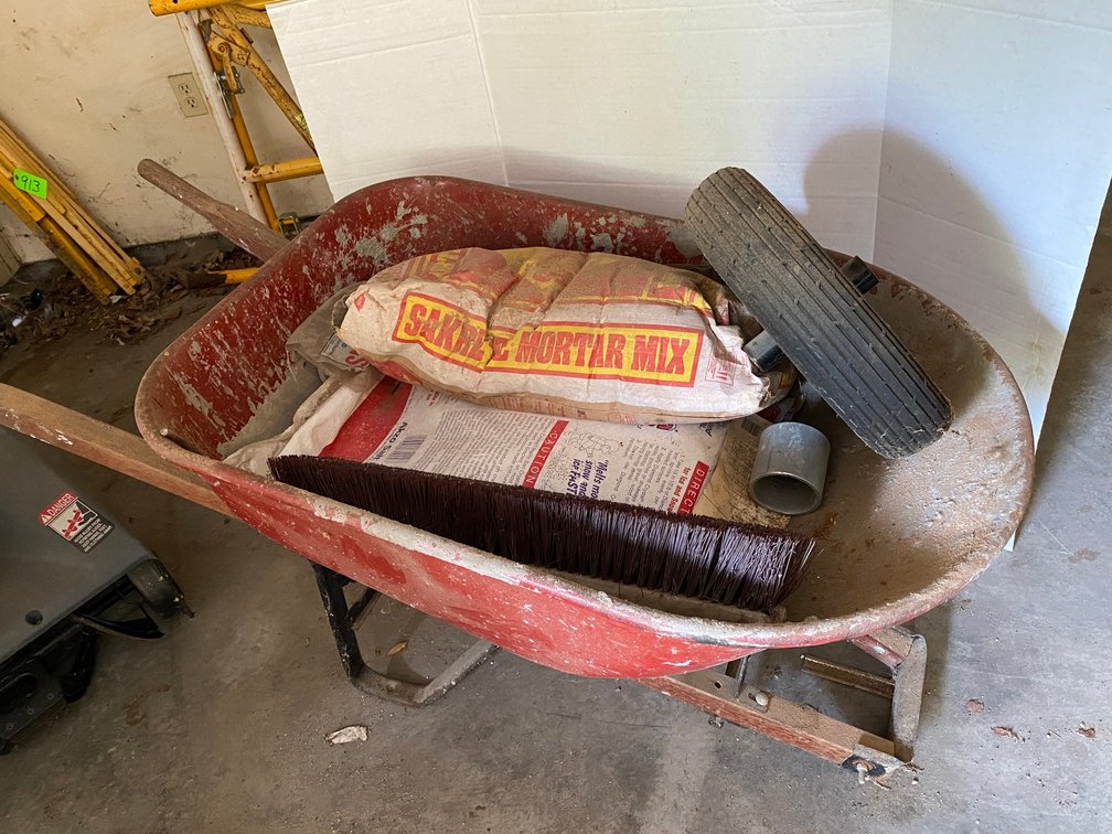Metal wheelbarrow**wheel has been removed but comes with it**has mortar mix and rock salt inside